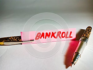 Bankroll related text displayed on green colour paper slip with pen concept