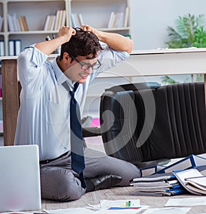 Bankrupt businessman angry in the office floor