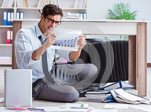 Bankrupt businessman angry in the office floor