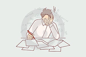 Bankrupt businessman is crying because of financial problems, sitting at table with tax documents