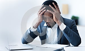 Bankruptcy. Frustrated black businessman depressed after fail at work.