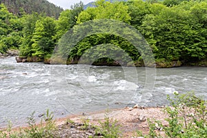 mountain river swift current, whirlpools in the flow of water in a granite canyon photo