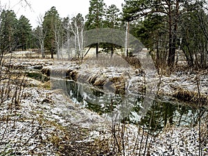 the banks of a small forest river in the early winter in the Middle Urals