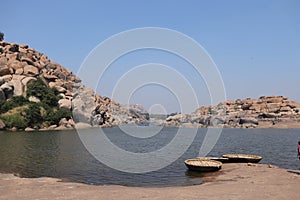 Banks of Tungabhadra river in Hampi, Karnataka - coracle boats ready for tourist rides
