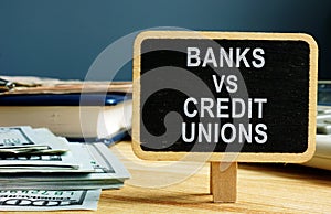 Banks vs Credit Unions concept. Money and ledger photo