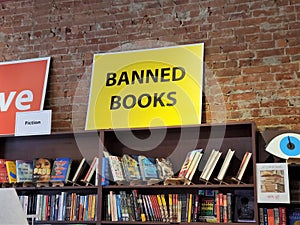 Banned Books sign above book titles on shelf