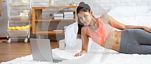 Banner Attractive Asian woman looking laptop practice yoga plank online course at home to meditation