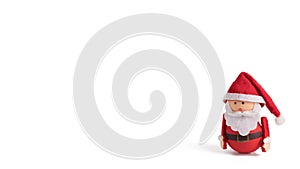Banner, backdrop or background with a cute Santa Claus Doll with copy space. Suitable for Christmas cards. Isolated Christmas doll