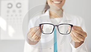 Banner background with an optician holding new eyeglasses and giving them to you
