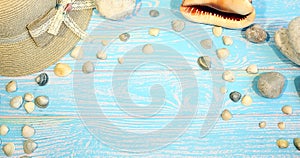 Banner with beach Female accessories on a blue board aquamarine color background. Hat, sea shells, sea stones. Travel and tourism