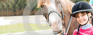 A sweet girl riding a white horse, an athlete engaged in equestrian sports, a girl hugs and kisses a horse.