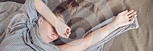 BANNER Beautiful young woman lying down in bed and sleeping, top view. Do not get enough sleep concept Long Format