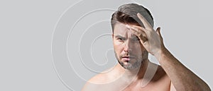 Banner of beauty male portrait of a beautiful man applying face cream. Moisturizing skincare cream for man. Mask for