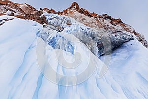 Banner blue clear ice cave on Baikal lake in winter landscape