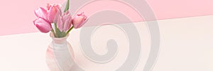 Banner with bouquet of tulip flowers in front of pink background.