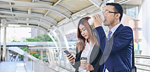 Banner Businessman Businesswoman drinking coffee in town using smartphone outside office city. Panorama Hands holding take away