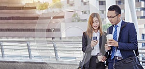 Banner Businessman Businesswoman drinking coffee in town using smartphone outside office city. Panorama Hands holding take away