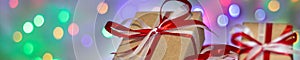 Banner of Christmas gift box against bokeh background. Holiday greeting card