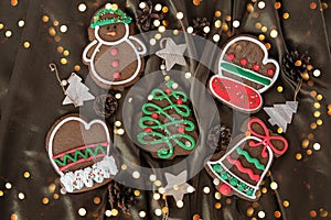 Banner for Christmas and New Year gingerbread. Christmas trees, toys, snowmen, garlands on a background of brown silk