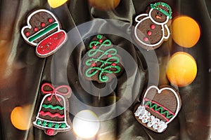 Banner for Christmas and New Year gingerbread. Christmas trees, toys, snowmen, garlands on a background of brown silk