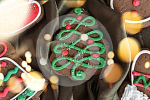 Banner for Christmas and New Year gingerbread. Christmas trees, toys, snowmen, garlands on a background of brown silk