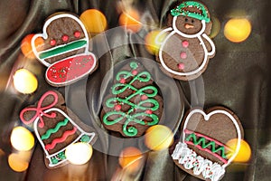 Banner for Christmas and New Year gingerbread. Christmas trees, toys, snowmen, garlands on a background of brown silk