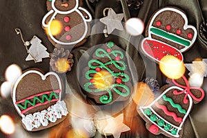 Banner for Christmas and New Year gingerbread. Christmas trees, toys, snowmen, garlands on a background of brown silk