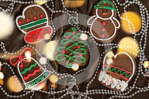 Banner for Christmas and New Year gingerbread. Christmas trees, toys, snowmen, garlands on a background of brown silk