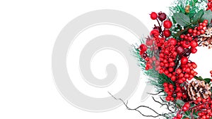 Banner with a Christmas wreath in red and green colors on a white background with copy space. Part of Christmas wreath for New