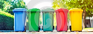 Banner with colorful recycling bins lined up outdoors,