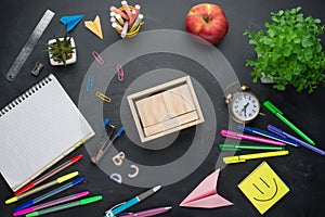 Banner concept Back to school Alarm clock, pencil Apple Notebook and blank calendar, Stationery on the background of the board. De