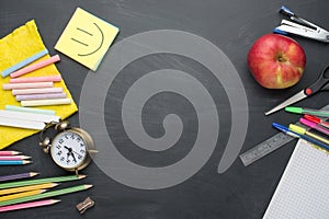 Banner concept Back to School Alarm clock, pencil Apple Notebook Stationery on blackboard background. Design Copy Space accessorie