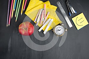 Banner concept Back to School Alarm clock, pencil Apple Notebook Stationery on blackboard background. Design Copy Space accessorie