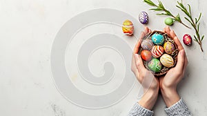 Banner with copyspace, man's hands holding a basket with Easter eggs, painted in various bright colors and decorated