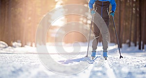 Banner cross-country skiing in winter on snowy track, sunset background