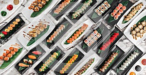 Banner with different sets of maki sushi rolls, nigiri and gunkan with tiger shrimp, tomago, salmon, tuna, chuka salad, tuna and