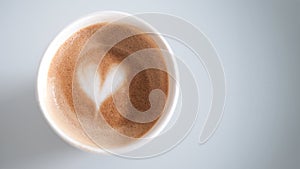 A banner with a eco cup with hot cappuccino coffee with foam and a heart pattern