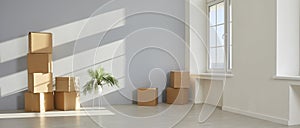 Banner with an empty room and cardboard boxes in a new house or apartment on moving day