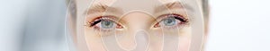 Banner with eyes of young woman. Close up cropped shot of young woman face with beautiful eyes. Good vision and eye care. Contact