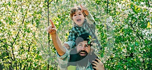 Banner for fathers day or father and son on spring background. Father and son on spring blossom garden background
