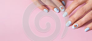 Banner with female hands with winter snow manicure with stickers under a matte top on pink background