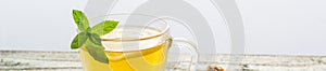 banner of Ginger tea with lemon mint and honey on a white wooden background. Hot healthy winter drink