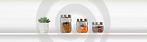 Banner with glass food storage canisters on white background