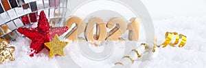 Banner golden numbers 2021 on snow, mirror disco ball and stars