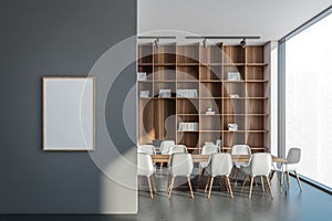 Banner on a grey wall with white chairs and shelving behind