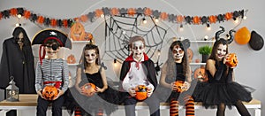 Banner with group of happy trick or treaters dressed up in spooky Halloween costumes