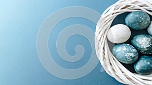 Banner of Group ight blue eggs in their nest on a blue background. Happy Easter decoration.