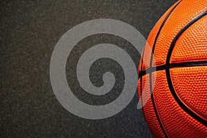 Banner with half of official orange leather basketball and dark black floor
