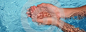 Banner the hands cupped together submerged in clean clear blue water in swimming pool