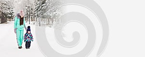 Banner happy family. Mother and child girl on a winter walk in nature with copy space